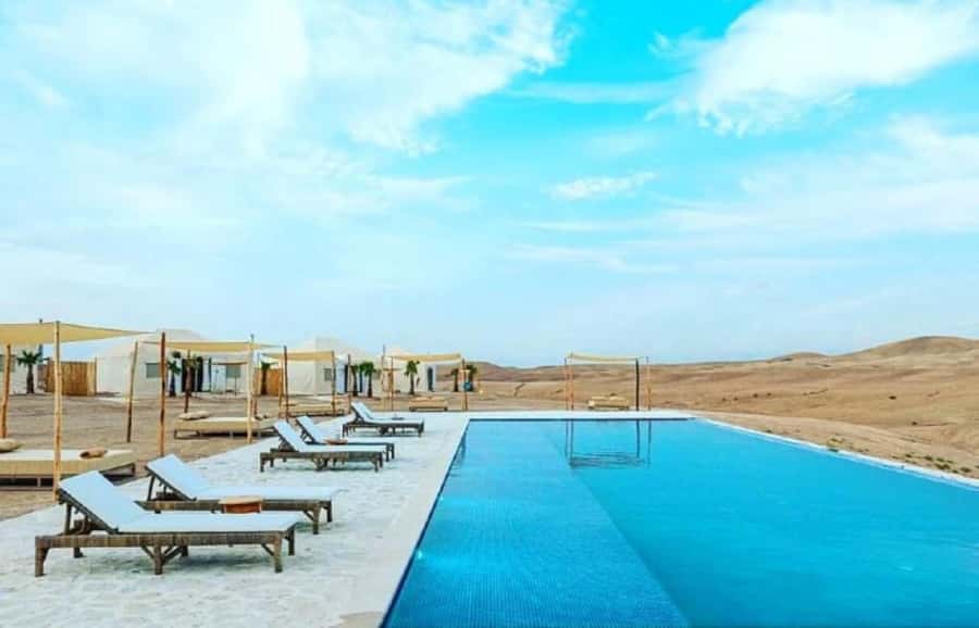 Agafay Desert Day: Quad Bike, Lunch & Swim Adventure - Camel riding in a rocky desert setting