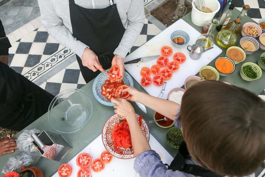 Marrakech: 3-Hour Open-Air Moroccan Cooking Course - Preparing tagine over the fire