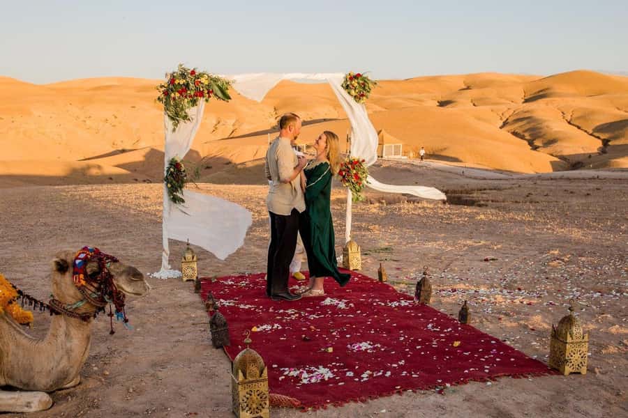 Marrakech Dinner Show Agafay Desert with Camels swiming pool - Riding a camel as the sun goes down