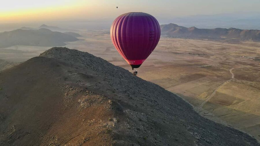 Marrakech: hot-air balloon flight with view of the Atlas Mountains and Berber breakfast - Tea, pastries, and the balloon taking shape