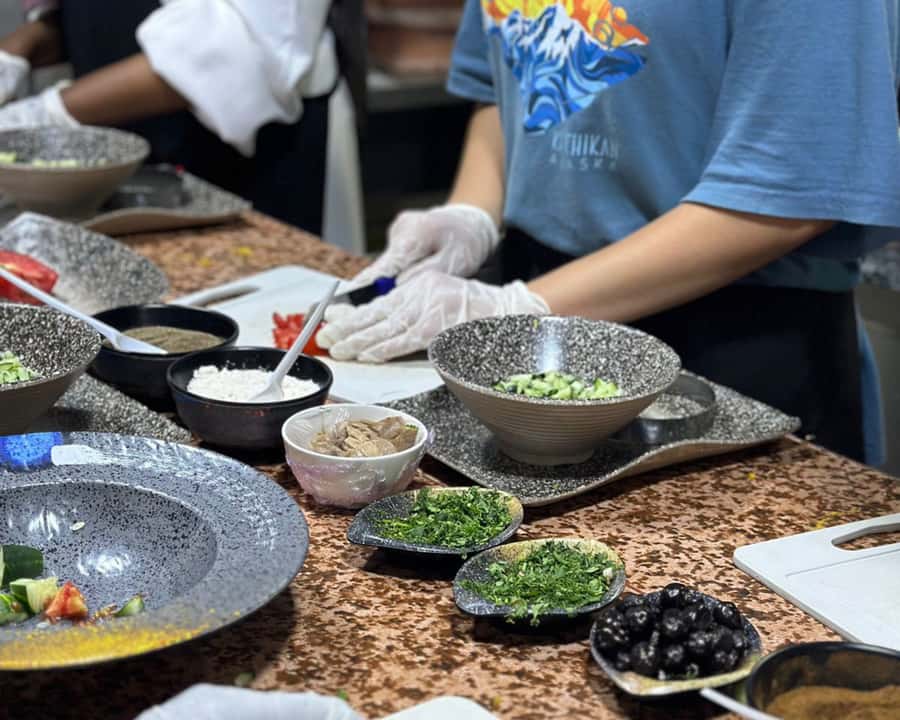 Marrakech: Moroccan Cooking Class with Pickup - Cooking tajine beside the restaurant chefs