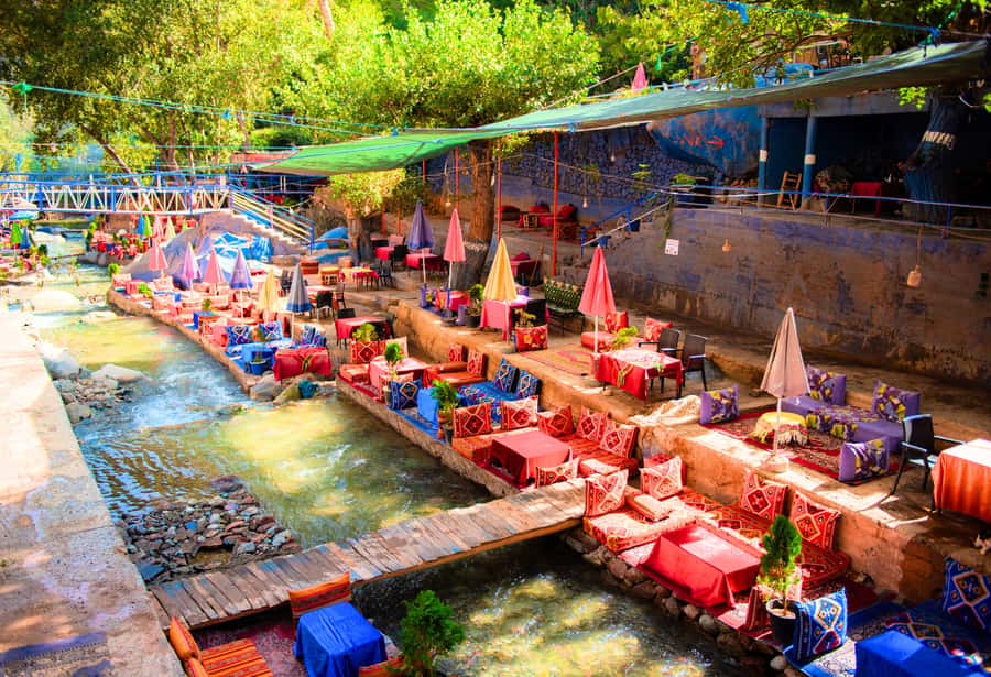 Marrakech: Ouzoud Waterfalls Trip, Guide & Boat + Lunch - Riding the wooden boat below the cascades